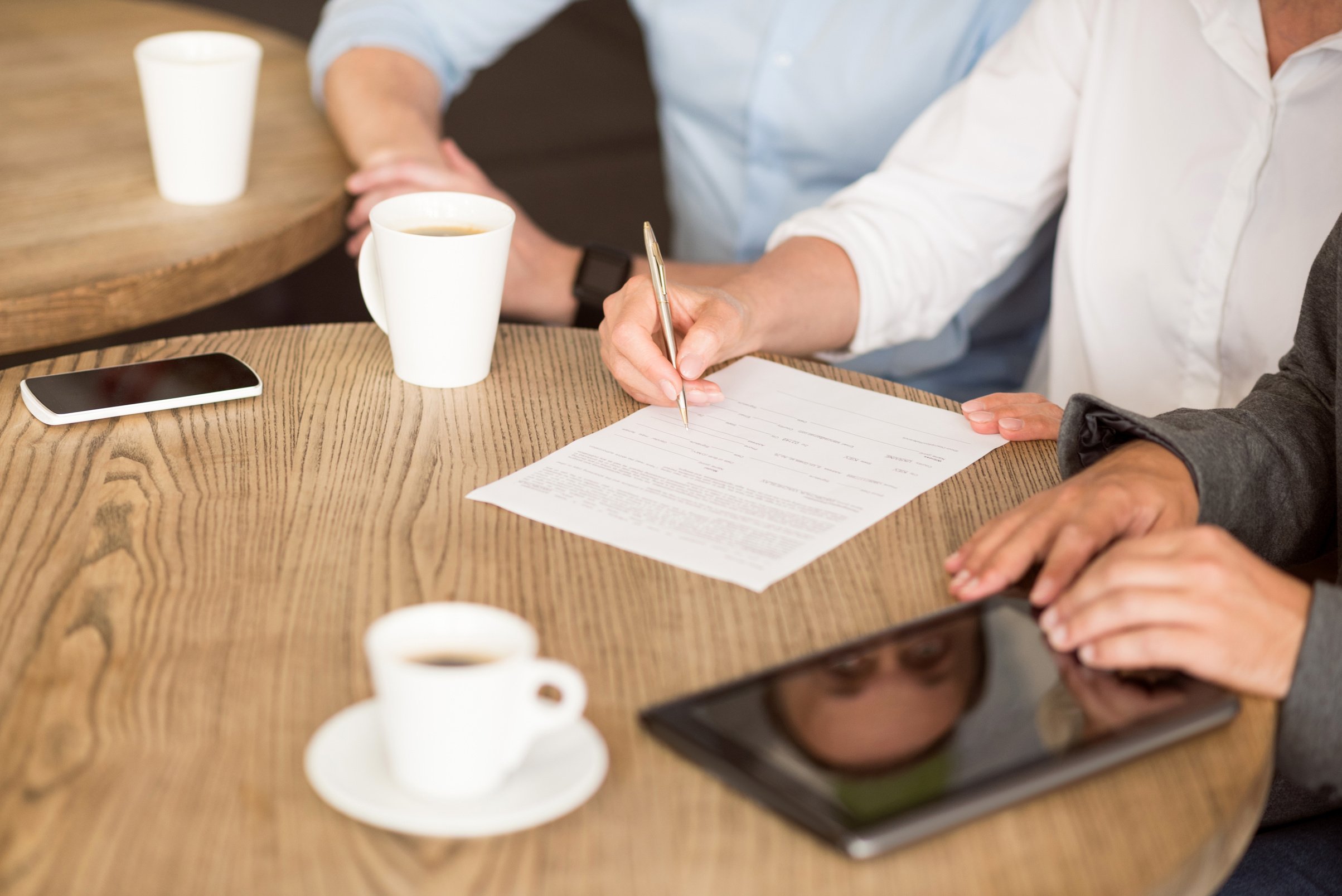 Pleasant woman signing papers
